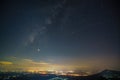 Panorama view universe space shot of milky way galaxy with stars on night sky background at mountains and city light landscape Royalty Free Stock Photo
