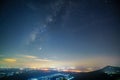 Panorama view universe space shot of milky way galaxy with stars on night sky background at mountains and city light landscape Royalty Free Stock Photo