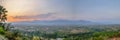 Panorama view of the village at sunset. The landscape view of a small village situated on a green hill in a valley surrounded by Royalty Free Stock Photo