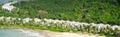 Panorama view white sandy beach with row houses, luxury vacation homes, ocean view villas surrounding by coconut palm trees, Royalty Free Stock Photo