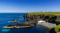Panorama view of the wild Caithness coast and the Noss Head Lighthouse Royalty Free Stock Photo