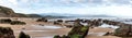 Panorama view of wild and rocky and sandy beach at low tide