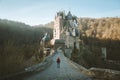 Hiker at Eltz Castle at sunrise, Rheinland-Pfalz, Germany