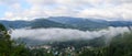 Panorama village in the mountains covered with misty clouds morn