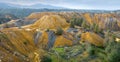 Panorama of vivid yellow tailings from abandoned Memi pyrite mine on Cyprus with area being restored and reforestation going on Royalty Free Stock Photo