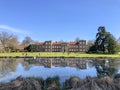 Panorama of The Vyne house with lake and water reflection Basingstoke, Hampshire, England. Taken on 17th April 2021 Royalty Free Stock Photo