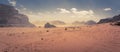 Panorama of the Wadi Rum desert in Jordan during a slight sand storm. Royalty Free Stock Photo