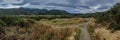 Panorama of walking path and mountainous landscape, South Island, New Zealand Royalty Free Stock Photo