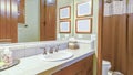 Panorama Warm bathroom lighting in California home with view of a sink and shower curtains