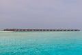 Panorama of Water Villas (Bungalows) and wooden jetty at Tropical beach in the Maldives at summer day Royalty Free Stock Photo