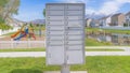 Panorama Whispy white clouds Cluster pedestal maibox near the playground and lake in a residential area at Utah valley