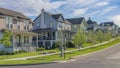 Panorama Whispy white clouds Row of large two-storey houses near the paved uphill road at Daybreak, Utah Royalty Free Stock Photo