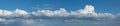 Panorama with white, fluffy Cumulus clouds on a blue sky in the daytime Royalty Free Stock Photo