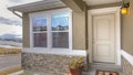 Panorama White front door and reflective window of a home against road and cloudy sky Royalty Free Stock Photo