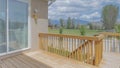 Panorama White puffy clouds Wooden deck of a fenced house with sliding glass door