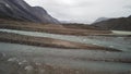 Panorama of wild river flowing to Summit lake in the remote arctic wilderness of Baffin Island, Nunavut, Canada
