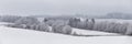 Panorama of winter forest covered by clouds. December fog on hills. Misty fall woodland. Snowstorm. Snowy fir, pine trees. Cold Royalty Free Stock Photo