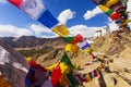 Panorama winter landscape of Leh palace with five color prayer flags blowing in the wind, Leh palace in the background. Royalty Free Stock Photo