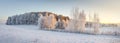 Panorama of winter nature landscape. Panoramic view on frosty trees on snowy meadow in morning with warm yellow sunlight
