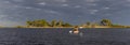 Panorama of woman kayaking in the Gulf of Mexico with birds flying overhead