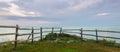 Panorama of a wooden fence on ocean shore in the morning Royalty Free Stock Photo