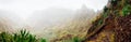 Panorama of Xo-Xo valley surrounded by harsh mountain peaks. Steep walk path covered by yucca plants lead down to Royalty Free Stock Photo