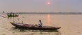Panorama of a young man in a row boat on the Ganges river in Varanasi