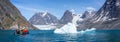 Panorama of Zodiac alongside an iceberg  with passengers in front of large glacier in Evighedsfjord, Greenland Royalty Free Stock Photo