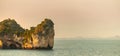 Panoramam of the scenic view of the rock cliff with woods outreachs from the land into the sea with the nearby beach in the Royalty Free Stock Photo