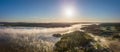 Panoramam of a sunrise at a lake with fog Royalty Free Stock Photo