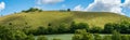 Panoramatic view of a hillside with The Cerne Abbas Giant, an ancient hill figure near the village of Cerne Abbas in Dorset, Engla Royalty Free Stock Photo