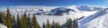 Panoramaview to ski slopes and skiers skiing in Kitzbuehel mountain ski resort with a background view to Alps in Austria Royalty Free Stock Photo