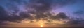 Panoramic abstraction of sunrise with dramatic blurred background of clouds and blue sky