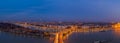 Panoramic Aerial drone shot of Margaret Bridge with lights on over Danube river during Budapest sunset