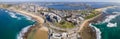 Panoramic aerial drone view of the harbour city of Newcastle, NSW, Australia as a cargo ship enters Newcastle Harbour Royalty Free Stock Photo