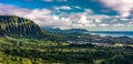 Panoramic aerial image from the Pali Lookout on the island of Oahu in Hawaii. With a bright green rainforest, vertical cliffs and Royalty Free Stock Photo