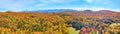 Panoramic aerial over peak fall forest mountains in Vermont with blue skies Royalty Free Stock Photo