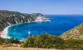 Panoramic aerial photo of man standing on top of a rock with an exciting feeling of freedom, looking at Petani Beach Royalty Free Stock Photo
