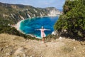 Panoramic aerial photo of a tourist woman enjoying beautiful Petani beach on Kefalonia Ionian island, Greece, during her