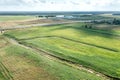 Panoramic aerial view of agricultural fields with irrigational channels and farm