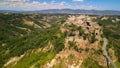 Panoramic aerial view of Civita di Bagnoregio from a flying drone around the medieval city, Italy