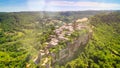 Panoramic aerial view of Civita di Bagnoregio from a flying drone around the medieval city, Italy