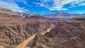 Panoramic aerial view of Colorado River weaving through valleys and rugged terrain seen from Plateau Point, Arizona, USA Royalty Free Stock Photo