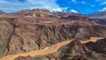 Panoramic aerial view of Colorado River weaving through valleys and rugged terrain seen from Plateau Point, Arizona, USA Royalty Free Stock Photo