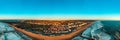 Panoramic aerial view of Costa da Caparica coastline of glorious sandy beaches, powerful waves. City near the ocean