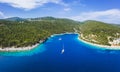 Panoramic aerial view of Foki Beach and sailing yacht boats moored in turquoise bay. Fiskardo, Kefalonia island, Greece Royalty Free Stock Photo
