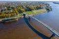 Panoramic aerial view of the Great Bridge and the Volkhov River in Veliky Novgorod, autumn trees on a sunny day. Frigate Flagship Royalty Free Stock Photo