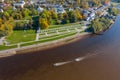 Panoramic aerial view of the Great Bridge and the Volkhov River in Veliky Novgorod, autumn trees on a sunny day. Motor boat and Royalty Free Stock Photo