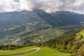 Panoramic aerial view of the hairpin bends that ascend Monte di Silandro, with Corzes in the background, Val Venosta, Italy