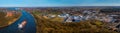 Panoramic aerial view of Kiel Canal with container ships and industrial park. Cargo ships on the Kiel Canal between Baltic sea and
